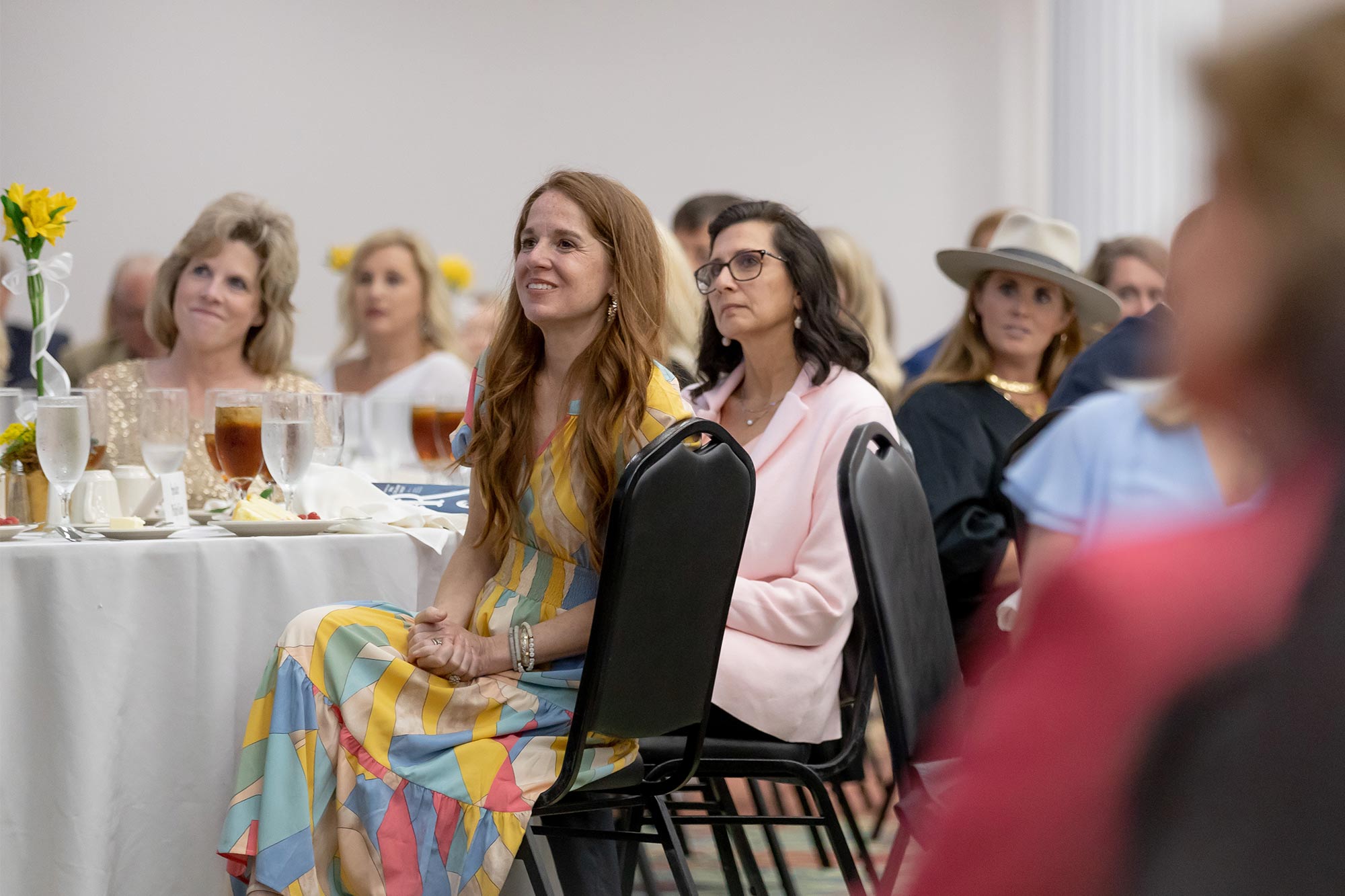 Women attending a banquet with students at MC